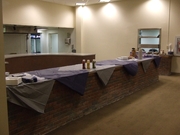 Image of kitchen bar with a wall opening in the background.